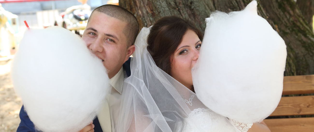 Customers enjoying candyfloss at a wedding